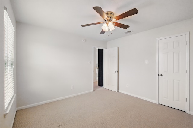 9034 Cedar Run Fls, Tomball, TX 77375 - unfurnished bedroom with light colored carpet, baseboards, and a ceiling fan