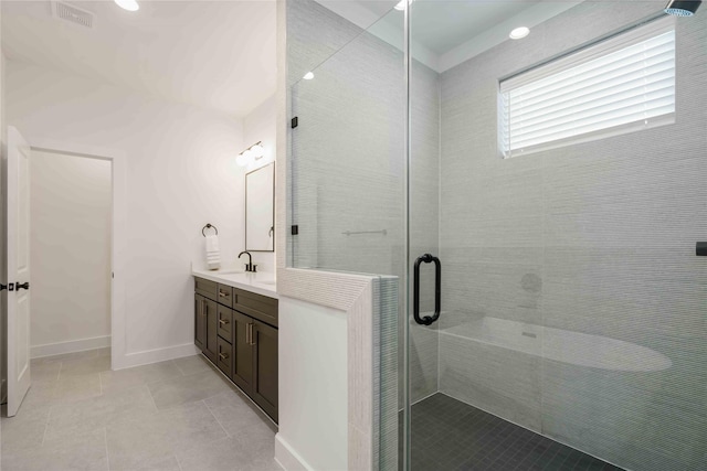 2520 Live Oak St, Houston, TX 77004 - full bathroom featuring a stall shower, double vanity, tile patterned flooring, and baseboards