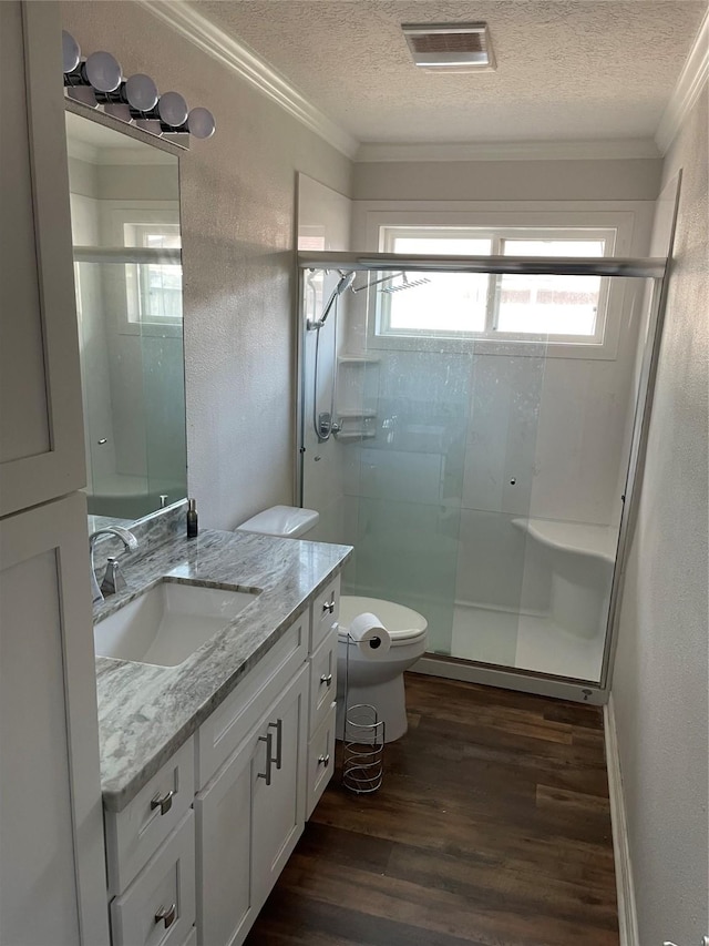 12955 Mintwood Dr, Beaumont, TX 77713 - bathroom with wood finished floors, toilet, crown molding, a textured ceiling, and vanity