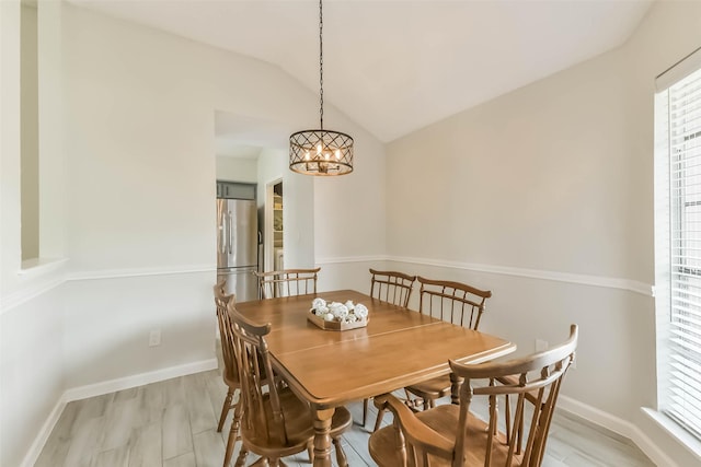 9819 Orangevale Dr, Spring, TX 77379 - dining area with healthy amount of natural light, light wood-style flooring, vaulted ceiling, and a chandelier