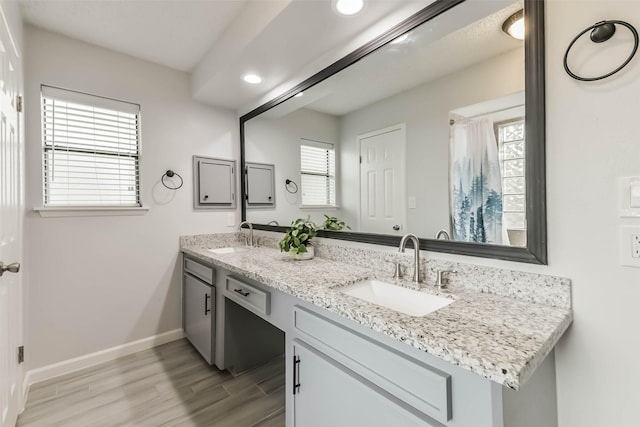 9819 Orangevale Dr, Spring, TX 77379 - full bath with double vanity, wood finished floors, baseboards, and recessed lighting