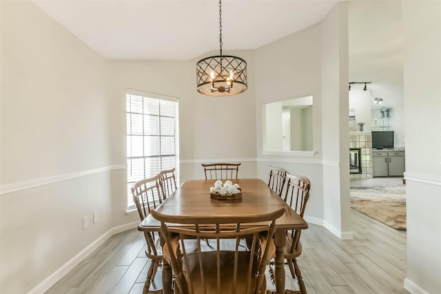 9819 Orangevale Dr, Spring, TX 77379 - dining area with light wood finished floors, a chandelier, and baseboards