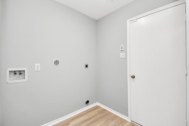 8907 Wildbird Ln, Humble, TX 77338 - washroom with electric dryer hookup, washer hookup, light wood finished floors, and baseboards