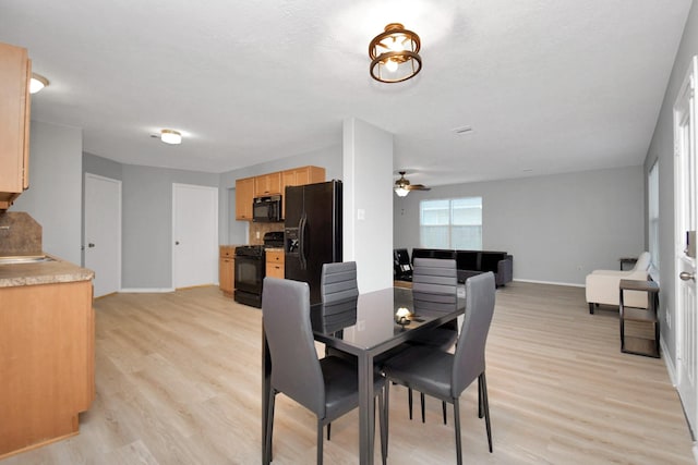8907 Wildbird Ln, Humble, TX 77338 - dining room featuring baseboards, ceiling fan, and light wood-type flooring