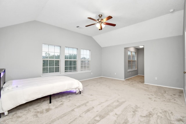 8907 Wildbird Ln, Humble, TX 77338 - carpeted bedroom featuring vaulted ceiling, baseboards, and a ceiling fan