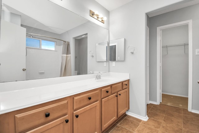 8907 Wildbird Ln, Humble, TX 77338 - full bath featuring vanity, baseboards, a spacious closet, and a shower with curtain
