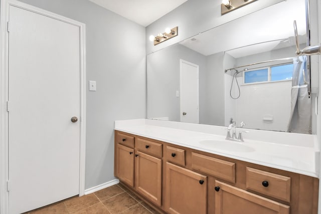 8907 Wildbird Ln, Humble, TX 77338 - full bathroom with vanity, curtained shower, baseboards, and tile patterned floors