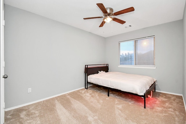 8907 Wildbird Ln, Humble, TX 77338 - bedroom with carpet, baseboards, and a ceiling fan