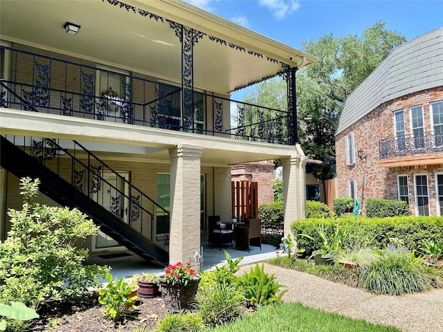 11550 Chimney Rock Rd Unit 329, Houston, TX 77035 - view of home's exterior with stairway, brick siding, and a balcony
