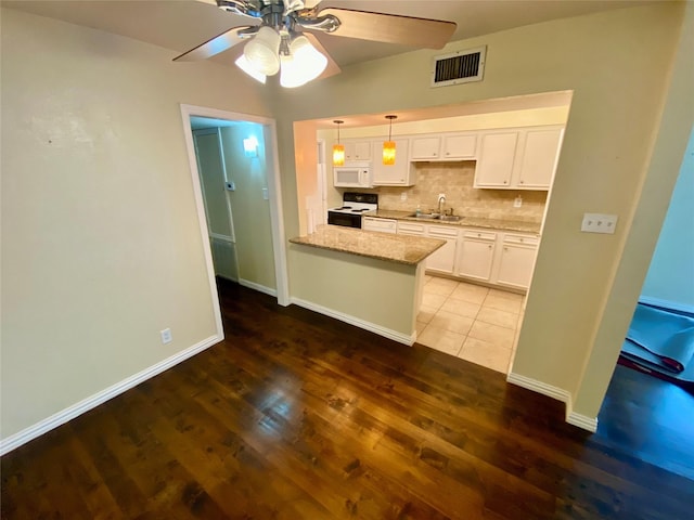 11550 Chimney Rock Rd Unit 329, Houston, TX 77035 - kitchen with range with electric cooktop, white microwave, a ceiling fan, a sink, and white cabinets