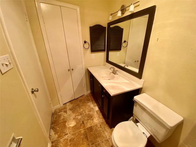11550 Chimney Rock Rd Unit 329, Houston, TX 77035 - bathroom featuring vanity, toilet, stone finish floors, and baseboards