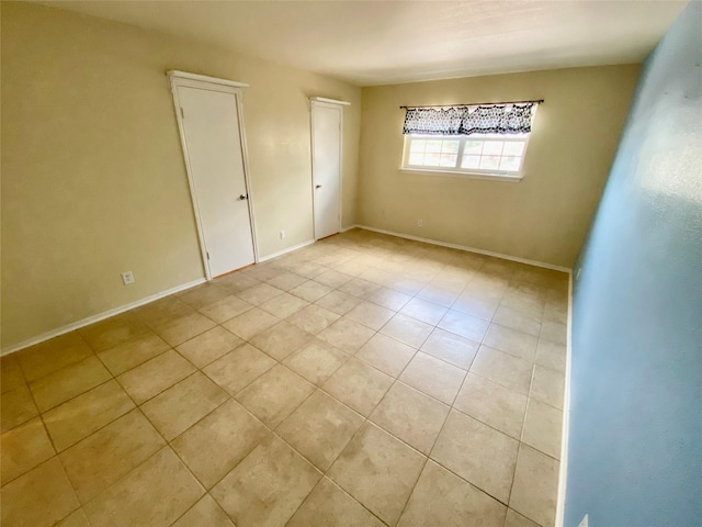 11550 Chimney Rock Rd Unit 329, Houston, TX 77035 - empty room with light tile patterned flooring and baseboards