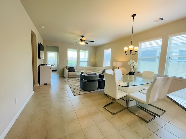 7927 Tindarey Maple Trce, Richmond, TX 77407 - dining area with a chandelier, a ceiling fan, baseboards, and light tile patterned floors