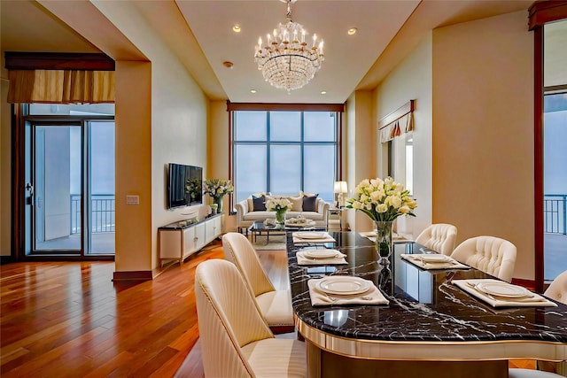 801 E Beach Dr Unit Tw2806, Galveston, TX 77550 - dining area featuring a chandelier, wood finished floors, and recessed lighting