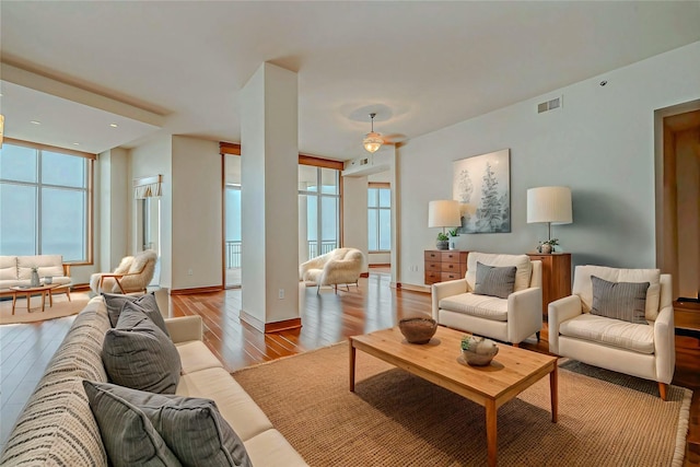 801 E Beach Dr Unit Tw2806, Galveston, TX 77550 - living room with healthy amount of natural light, wood-type flooring, and baseboards