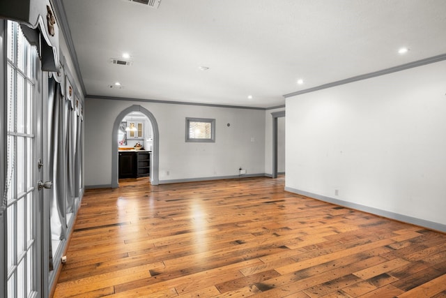 13106 Lookout Mountain Ct, Houston, TX 77069 - spare room featuring ornamental molding, light wood-style flooring, arched walkways, and recessed lighting