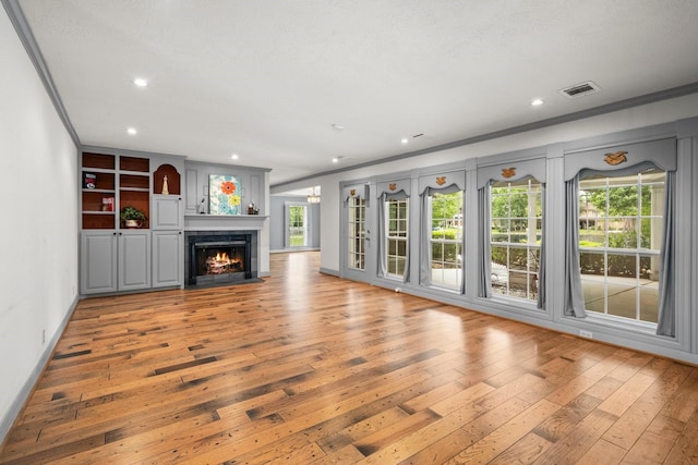 13106 Lookout Mountain Ct, Houston, TX 77069 - unfurnished living room with light wood finished floors, ornamental molding, recessed lighting, and a fireplace with flush hearth