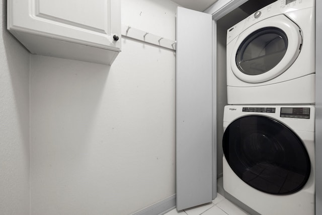 13106 Lookout Mountain Ct, Houston, TX 77069 - washroom featuring stacked washing machine and dryer and light tile patterned floors