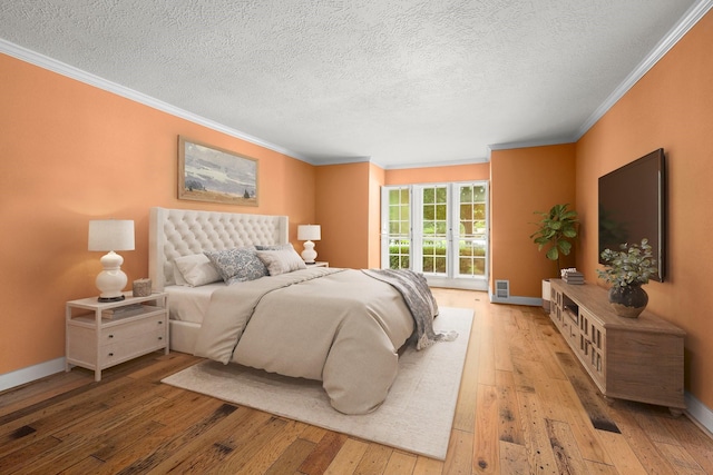 13106 Lookout Mountain Ct, Houston, TX 77069 - bedroom featuring ornamental molding, light wood-type flooring, and a textured ceiling