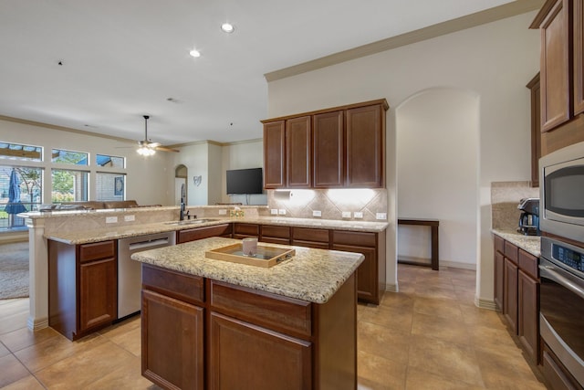14610 Thunder Bay, Beach City, TX 77523 - kitchen featuring appliances with stainless steel finishes, arched walkways, a peninsula, a sink, and backsplash