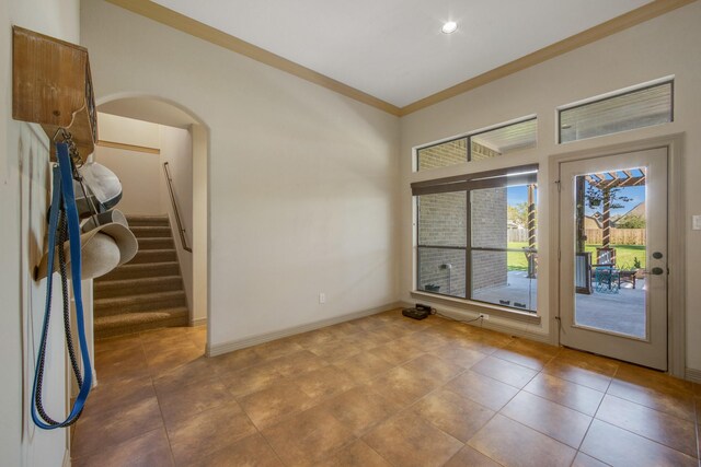 14610 Thunder Bay, Beach City, TX 77523 - tiled empty room with ornamental molding, arched walkways, baseboards, and stairs