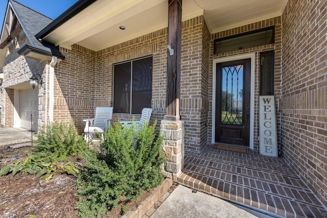 14610 Thunder Bay, Beach City, TX 77523 - entrance to property featuring brick siding, an attached garage, and a porch