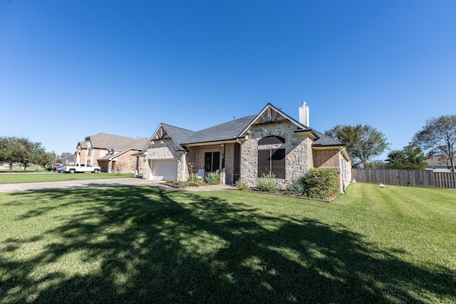 14610 Thunder Bay, Beach City, TX 77523 - view of front of house with stone siding, a chimney, and an attached garage