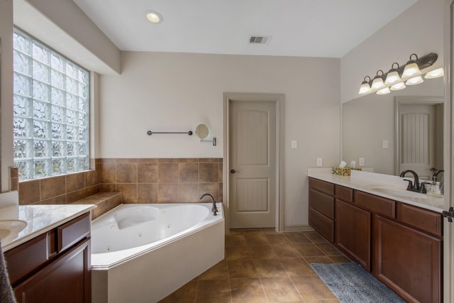 14610 Thunder Bay, Beach City, TX 77523 - full bathroom with healthy amount of natural light, two vanities, and a tub with jets