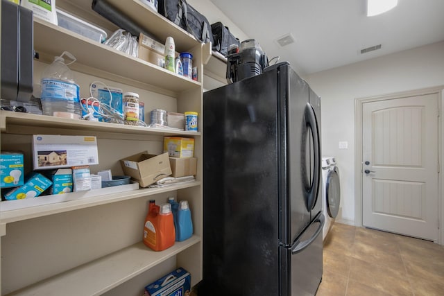 14610 Thunder Bay, Beach City, TX 77523 - laundry room with washing machine and clothes dryer and tile patterned floors
