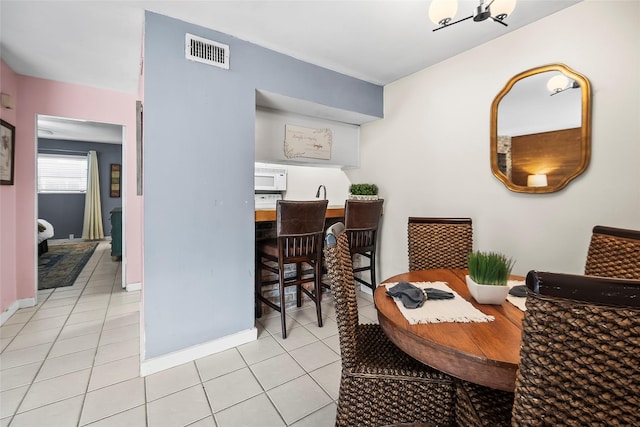 5353 Richmond Ave Unit 6, Houston, TX 77056 - dining space featuring light tile patterned floors and baseboards