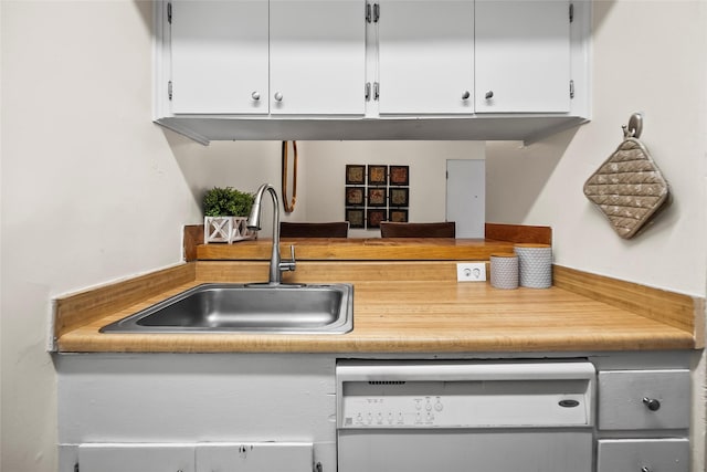 5353 Richmond Ave Unit 6, Houston, TX 77056 - kitchen featuring white dishwasher, a sink, white cabinetry, and light countertops