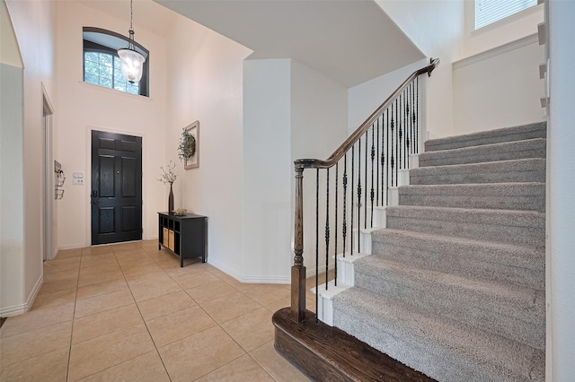 5003 Crystal Wind Ln, Katy, TX 77494 - foyer with a high ceiling, stairs, baseboards, and tile patterned floors