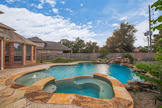 5003 Crystal Wind Ln, Katy, TX 77494 - view of swimming pool with a pool with connected hot tub and a fenced backyard