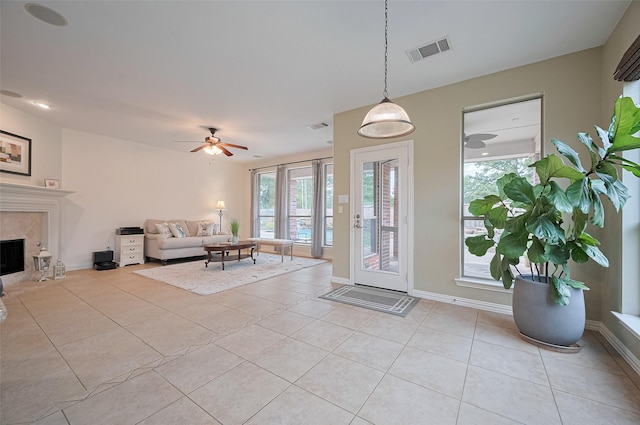 5003 Crystal Wind Ln, Katy, TX 77494 - foyer entrance with light tile patterned flooring, a high end fireplace, a ceiling fan, and baseboards