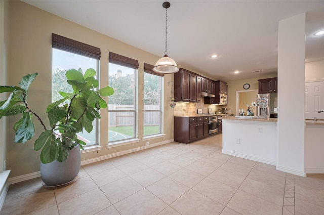 5003 Crystal Wind Ln, Katy, TX 77494 - kitchen featuring dark brown cabinets, stainless steel fridge with ice dispenser, light countertops, light tile patterned floors, and tasteful backsplash