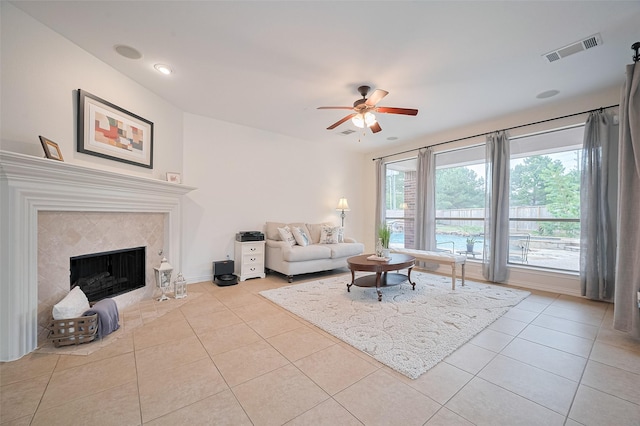 5003 Crystal Wind Ln, Katy, TX 77494 - tiled living area with a ceiling fan, a tiled fireplace, and baseboards