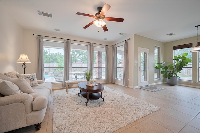 5003 Crystal Wind Ln, Katy, TX 77494 - living room featuring light tile patterned flooring, a ceiling fan, and baseboards