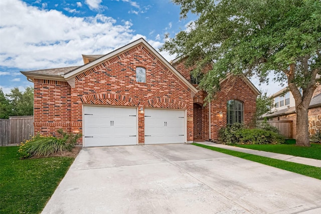 5003 Crystal Wind Ln, Katy, TX 77494 - traditional-style house featuring brick siding, driveway, and an attached garage