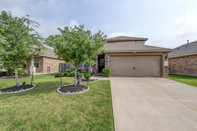 18214 Grayson Bluff Way, Richmond, TX 77407 - view of front of home featuring an attached garage, concrete driveway, a front lawn, and brick siding