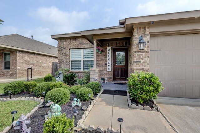 18214 Grayson Bluff Way, Richmond, TX 77407 - property entrance featuring brick siding and a garage