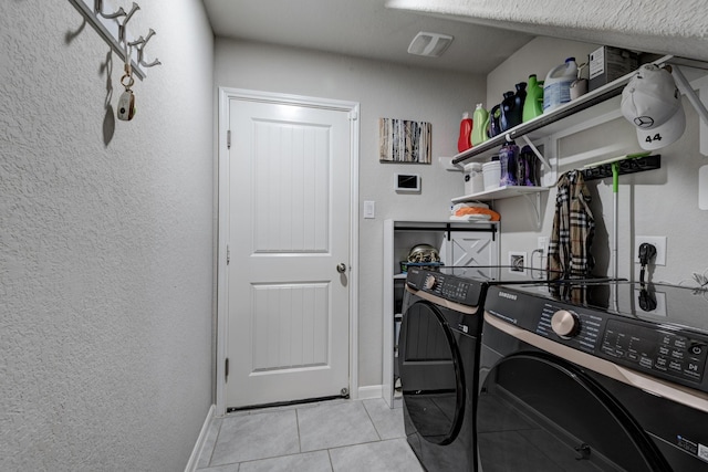 18214 Grayson Bluff Way, Richmond, TX 77407 - washroom with separate washer and dryer, light tile patterned floors, baseboards, and a textured wall