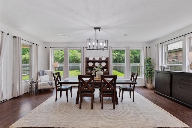 3933 Eagle Nest Lake Ln, Magnolia, TX 77354 - dining area featuring a chandelier and dark wood-style flooring