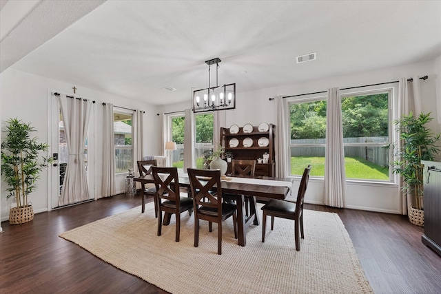 3933 Eagle Nest Lake Ln, Magnolia, TX 77354 - dining room featuring dark wood-style flooring, a chandelier, and baseboards