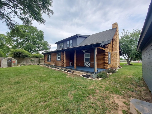 21403 Briar Meadow Rd N, Hempstead, TX 77445 - back of house featuring log siding, a greenhouse, an outbuilding, and ceiling fan