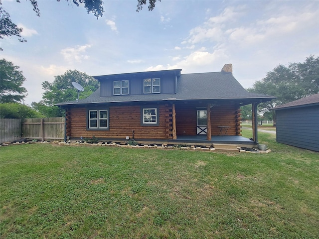 21403 Briar Meadow Rd N, Hempstead, TX 77445 - back of house with log exterior, a porch, and a chimney
