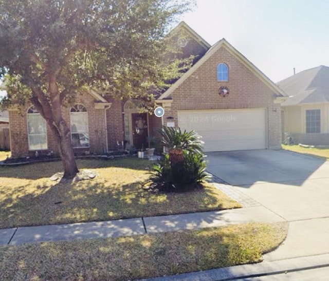 922 N Sky Dr, Houston, TX 77073 - view of front of house with brick siding, an attached garage, and driveway