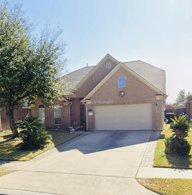 922 N Sky Dr, Houston, TX 77073 - view of front of home with brick siding, concrete driveway, and an attached garage