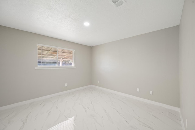 2414 Camillia St, Highlands, TX 77562 - spare room with light marble finish floors, baseboards, a textured ceiling, and recessed lighting