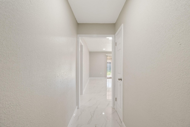 2414 Camillia St, Highlands, TX 77562 - hall with light marble finish floors, a textured wall, and baseboards