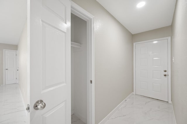 2414 Camillia St, Highlands, TX 77562 - hallway featuring light marble finish floors and baseboards